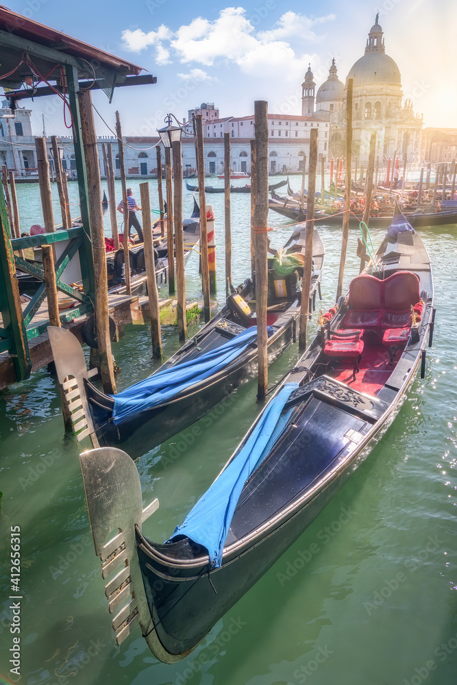 Venetian gondola moored in a traditional canal of Venice, Italy.