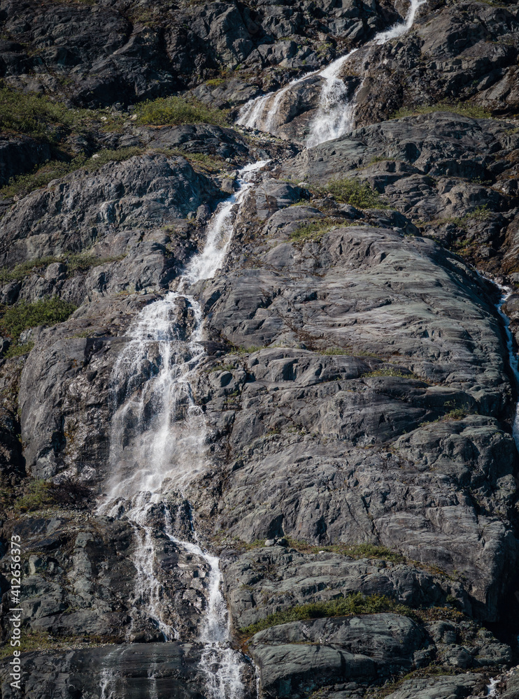 Natural waterfalls created by glacier melts in Alaska