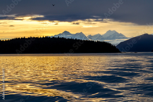 Silhouette of mountains before colorful sunset in Alaska photo
