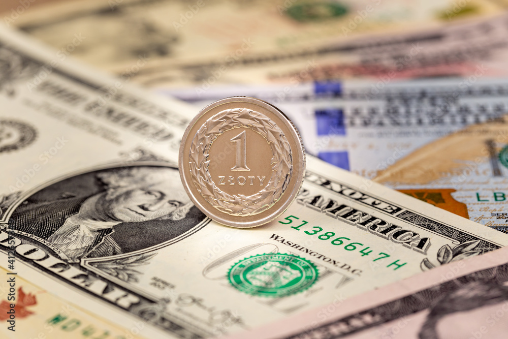 One Polish zloty coin on USA dollars currency banknotes exchange business background