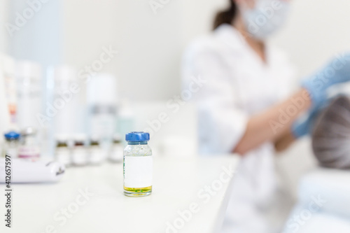 Flu vaccine in a glass jar. Vaccination against coronavirus