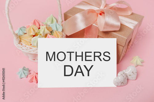 Gifts with note letter on isolated pink background with sweets, love and valentine concept with text mothers Day