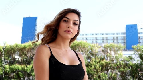 Beautiful Latina woman at the beach feeling confident and happy 