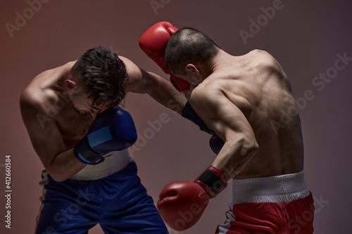 Wrestling of two fighting males, boxers during battle, knockout, martial arts, mixed fight concept © Georgii
