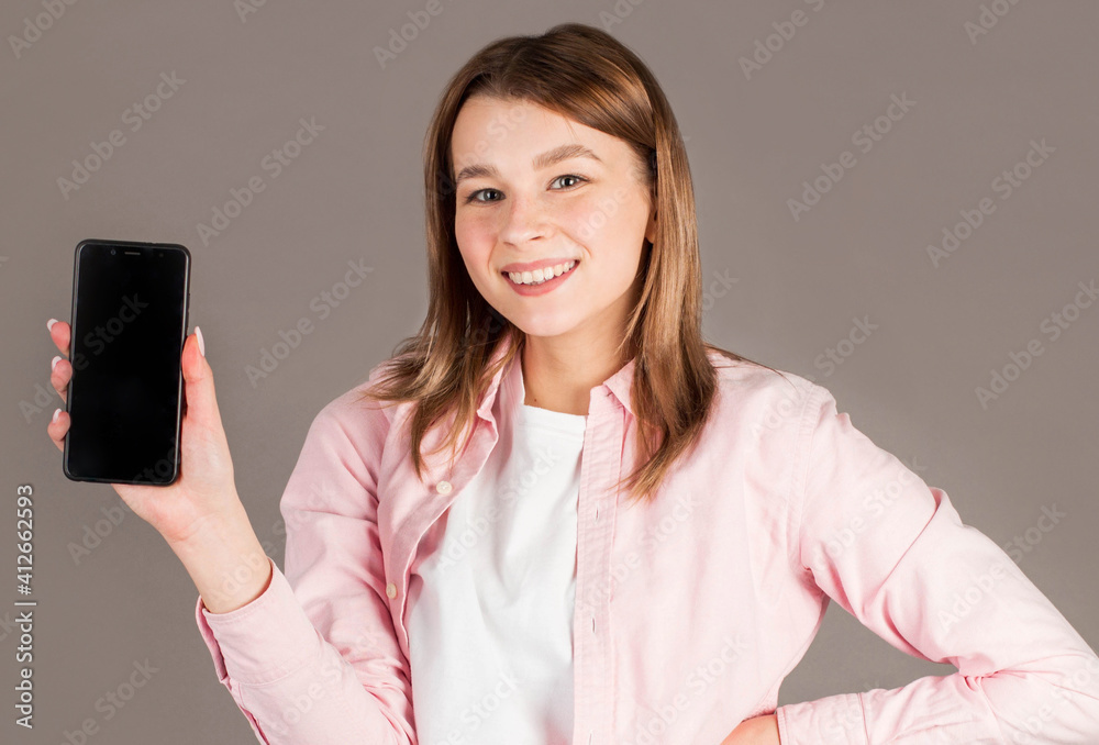 Banner of Happy woman feeling happiness and standing hold smartphone on gray background