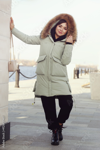 asian business woman in white down jacket with fur collar hood full body photo