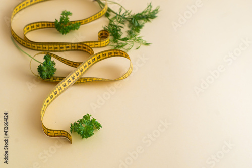 Diet concept on yulow background with measuring tape isolated