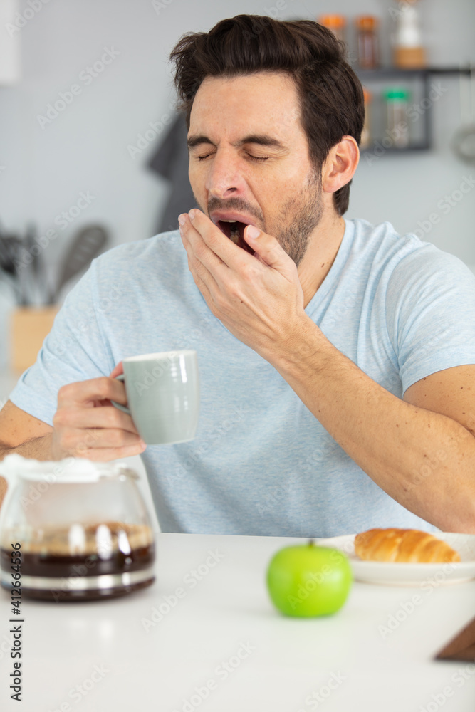 male business executive yawning in office male business executive yawning in office