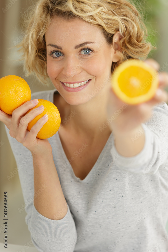 a woman is holding oranges a woman is holding oranges