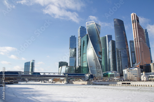 City landscape in sunny winter day with the view of the Moscow-City buildings and frozen river