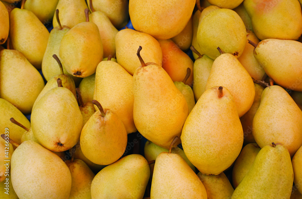 Fresh ripe pears as background, top view.