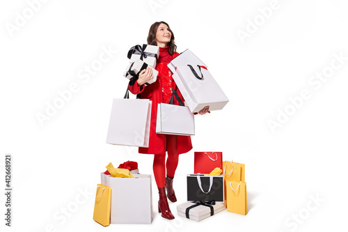 Woman shopaholic standing and holding bags with purchases © Yakobchuk Olena