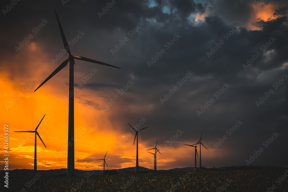wind turbines at sunset in bad weather wind turbines at sunset in bad weather