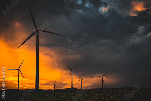 wind turbines at sunset in bad weather
