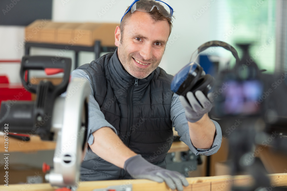 construction worker showing ear protection to camera
