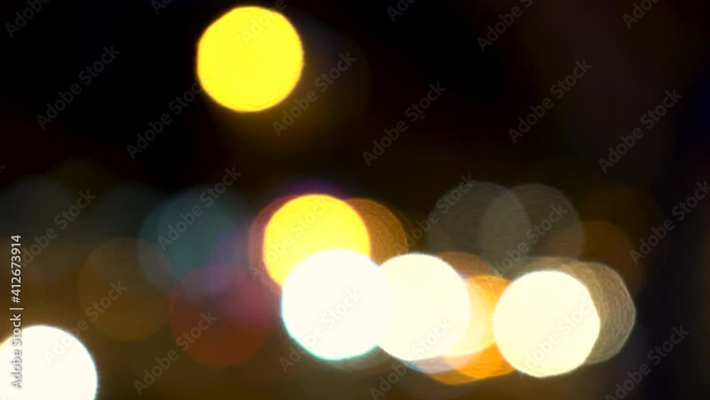 Defocused or soft focus bokeh lights of cars, scooters, motorbikes and traffic driving on city streets at night Defocused or soft focus bokeh lights of cars, scooters, motorbikes and traffic driving on city streets at night