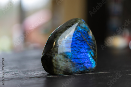 Labradorite mineral stone on slate worktop.