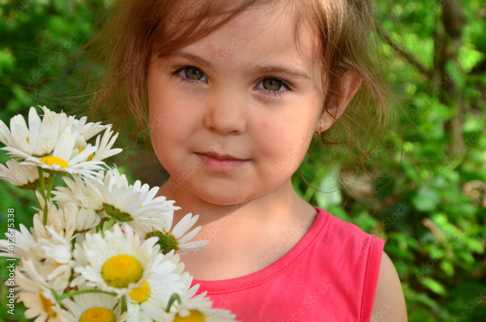 Cute little smiling girl in the bouquet of chamomile field in spring or summer, happy childhood, mother's day Cute little smiling girl in the bouquet of chamomile field in spring or summer, happy childhood, mother's day