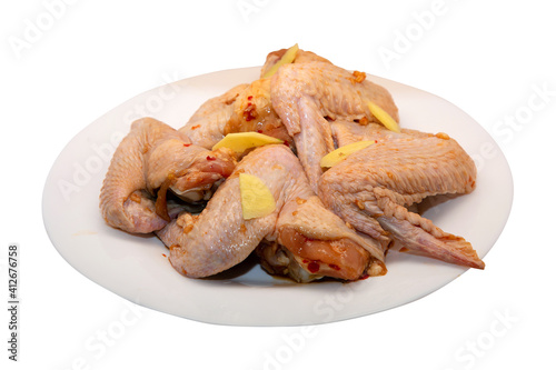 raw marinated chicken wings cooked for roasting and isolated on white background to create your menu