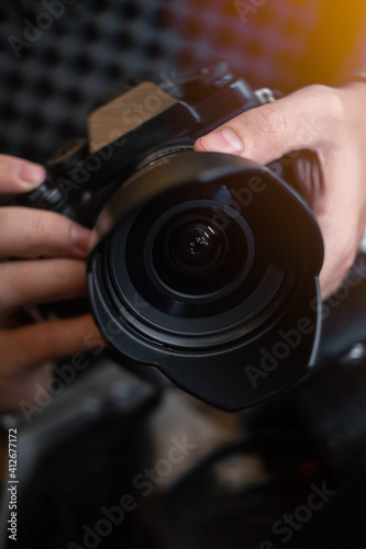 close up of hands holding a camera and taking a picture
