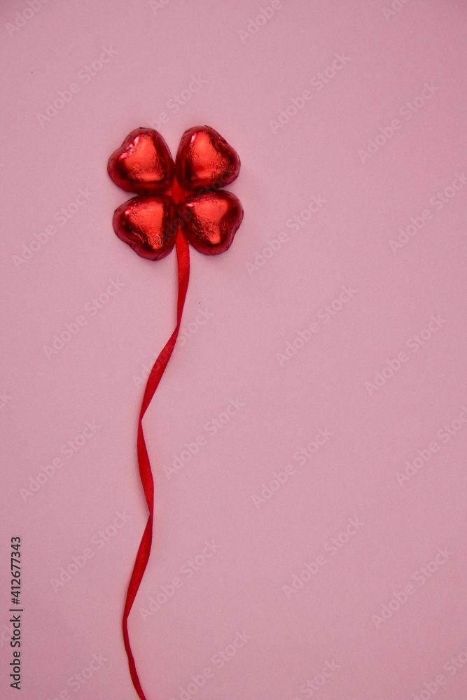 St Valentines romantic love concept - Four red chocolate hearts forming clover leaf