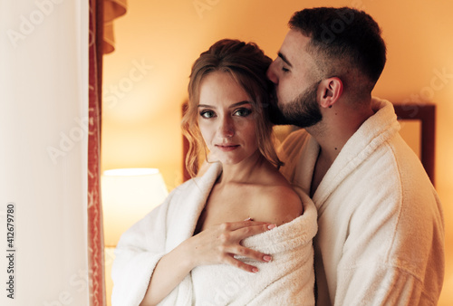 lovers in bathrobes in the bedroom