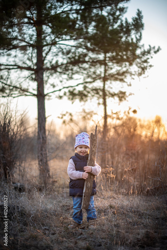  child in the forest at sunset spring