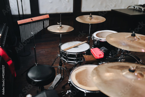 Canvas Print Two vintage wooden drumsticks are on the drum kit near the cymbals