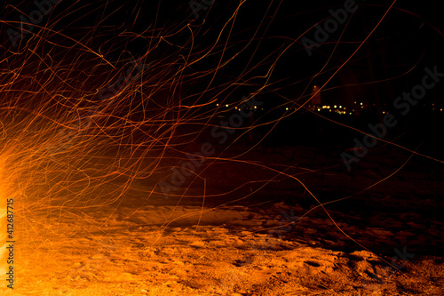 Beautiful shot of flying sparks from a firea photo