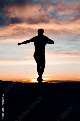 Wallpaper Mural VERTICAL IMAGE OF A PERSON RUNNING AT THE TOP OF A MOUNTAIN. MAN ENJOYING AND HAVING FUN DURING SUNSET. OUTDOOR AND SUNSET CONCEPT. Torontodigital.ca