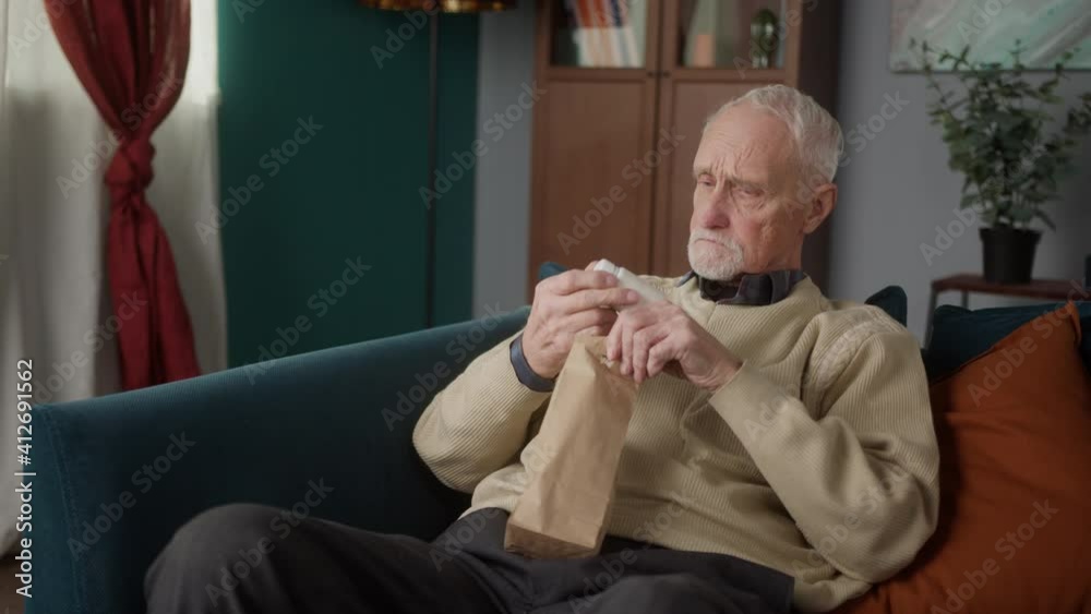 Old man unpacking drugs pills pharmacy delivery box, elderly senior male check vitamins and pills at home, pensioner in nursing home