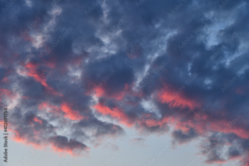 Dramatic dark blue and red clouds in sky