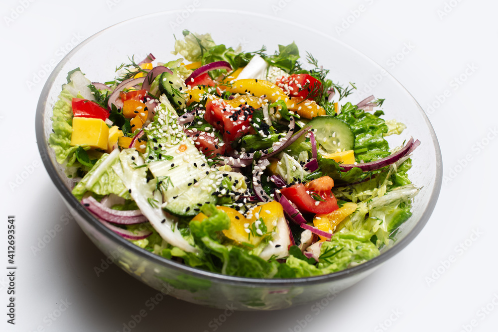 Close-up of transparent bowl with green salad on white background. Close-up of transparent bowl with green salad on white background.