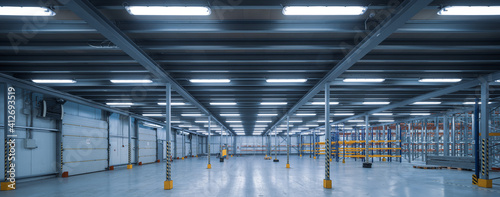 Interior of huge empty storehouse. Industrial warehouse racking.