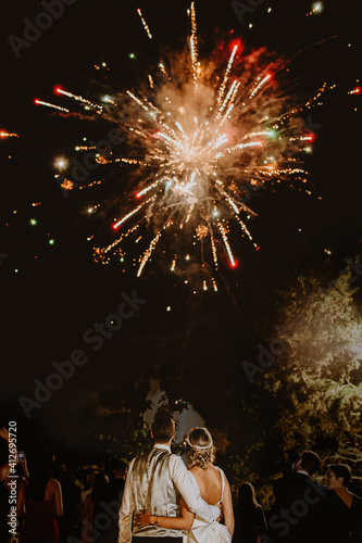 Young couple on their wedding contemplating some fireworks