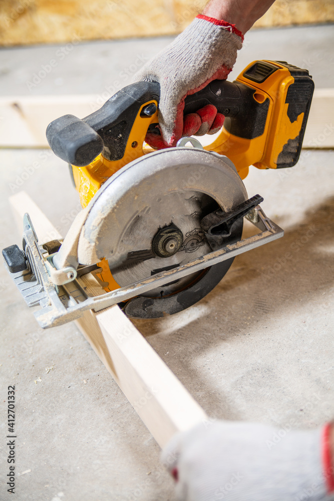 Cutting a wood board with a circular saw.