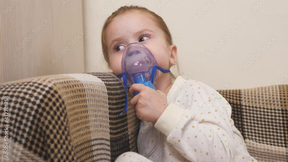 The child is receiving respiratory therapy with a nebulizer. Mommy