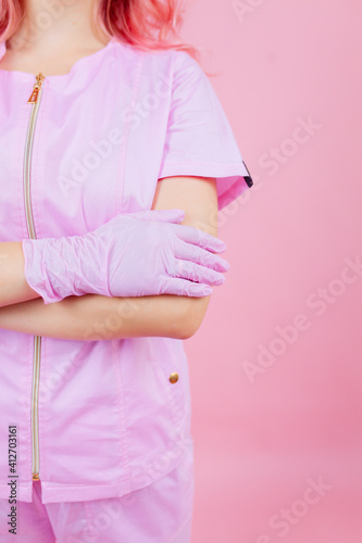 Wallpaper Mural Croped portrait of attractive pink-haired female doctor wearing safety pink uniform crossing arms contamination prevention isolated pink pastel color background Torontodigital.ca