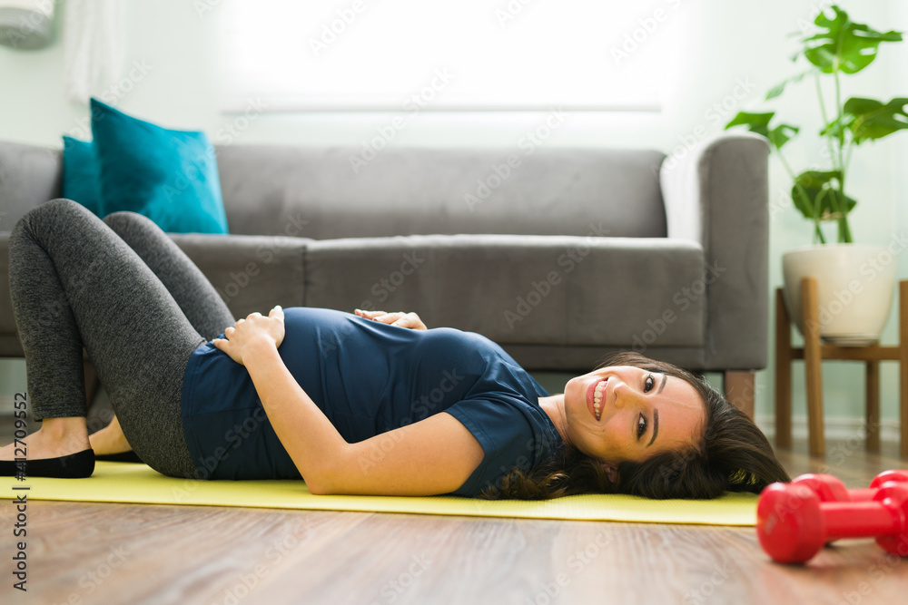 Portrait of a young pregnant woman resting from exercising