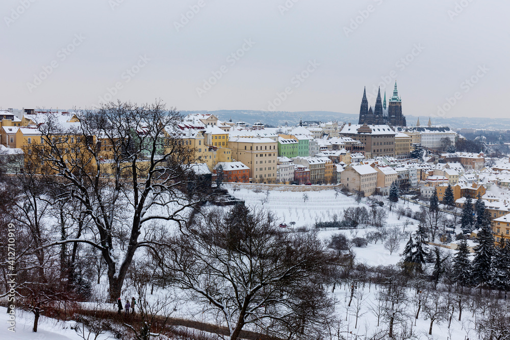 Snowy Prague City with gothic Castle from Hill Petrin, Czech republic