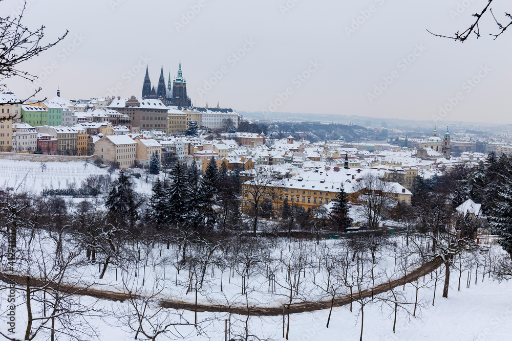 Snowy Prague City with gothic Castle from Hill Petrin, Czech republic