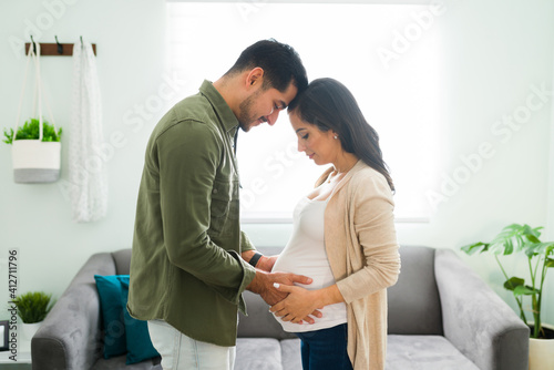 Fotografie Caring husband caressing the belly of a pregnant woman