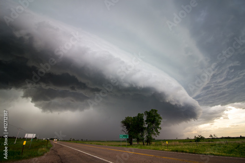 A shelf cloud approaches over a highway in the plains preceding a derecho. photo