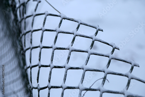 abstract background of metal mesh and snow