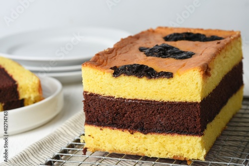spiku lapis surabaya or three layers of sponge cake made from lots of egg yolks with strawberry jam between the layers, served for Christmas, Chinese New Year or Eid and Eid Al-Adha
