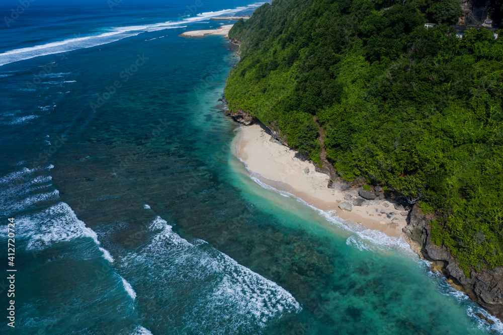 Aerial drone view of Green Bowl beach located on the Southern coast of Bali in Indonesia.