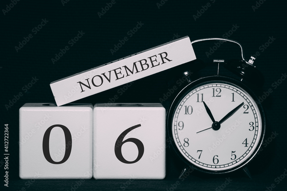 Obraz premium Important date and event on a black and white calendar. Cube date and month, day 6 November. Autumn season.
