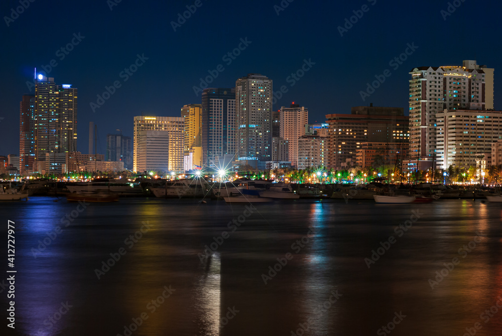 Evening shot of the beautifully illuminated City of Manila skyline 