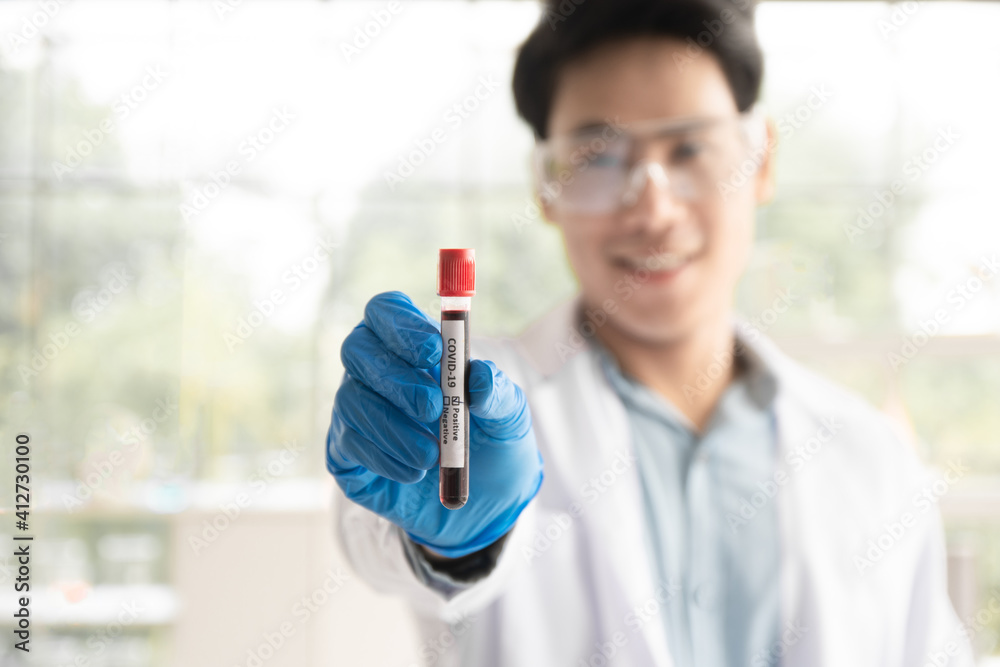 Scientist Holding a test tube in the lab, Doctors are researching a vaccine for the coronavirus. Scientist Holding a test tube in the lab, Doctors are researching a vaccine for the coronavirus.