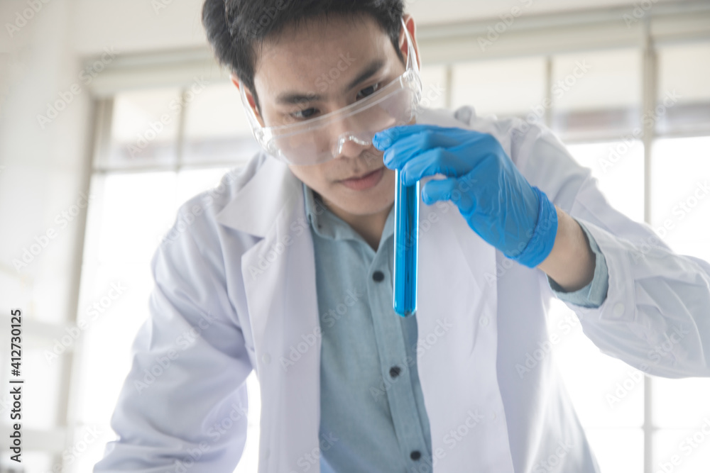 Scientist Holding a test tube in the lab, Doctors are researching a vaccine for the coronavirus. Scientist Holding a test tube in the lab, Doctors are researching a vaccine for the coronavirus.